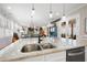 Open concept kitchen with island, double sink, and views to living room at 304 Woodstock Seven Dr, Woodstock, GA 30188