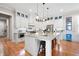 Bright kitchen featuring white cabinets, granite island, and stainless steel appliances at 304 Woodstock Seven Dr, Woodstock, GA 30188