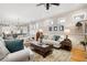 Open living room with kitchen views, comfortable seating and hardwood floors at 304 Woodstock Seven Dr, Woodstock, GA 30188