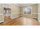 Formal dining room with hardwood floors and window view at 4830 Chesterfield Ct, Suwanee, GA 30024