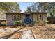 Newly renovated ranch home with blue door and landscaped yard at 501 Aberdeen Nw Dr, Atlanta, GA 30318