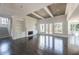 Open living room with fireplace, built-in shelves, and large windows overlooking backyard at 816 Hillwood Dr, Marietta, GA 30068