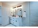 Modern bathroom with double vanity, marble tile, and black fixtures at 1930 Pinedale Nw Dr, Atlanta, GA 30314