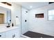 Spa-like bathroom with a large shower, marble tile and black fixtures at 1930 Pinedale Nw Dr, Atlanta, GA 30314