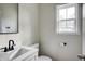 Simple bathroom with white vanity, black fixtures, and a window at 1930 Pinedale Nw Dr, Atlanta, GA 30314
