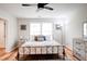 Bright bedroom with king-size bed, dresser, and ceiling fan at 1930 Pinedale Nw Dr, Atlanta, GA 30314