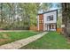Modern two-story house with wood and white exterior, landscaped lawn, and fenced yard at 1930 Pinedale Nw Dr, Atlanta, GA 30314