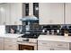Modern kitchen with stainless steel appliances and dark-colored backsplash at 1930 Pinedale Nw Dr, Atlanta, GA 30314