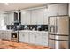 Modern kitchen with gray cabinets, stainless steel appliances, and white countertops at 1930 Pinedale Nw Dr, Atlanta, GA 30314