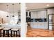 Open concept kitchen with breakfast bar, gray cabinets, and stainless steel appliances at 1930 Pinedale Nw Dr, Atlanta, GA 30314