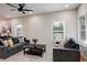 Bright living room with hardwood floors, gray sofas, and large windows at 1930 Pinedale Nw Dr, Atlanta, GA 30314