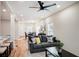 Open living room with hardwood floors, gray sofas, and a ceiling fan at 1930 Pinedale Nw Dr, Atlanta, GA 30314