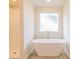 Bathroom featuring a freestanding bathtub and shower at 1621 Fuma Leaf Way, Mcdonough, GA 30253
