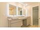 Spa-like bathroom with double vanity, granite countertop, and LED lit mirrors at 1621 Fuma Leaf Way, Mcdonough, GA 30253