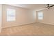 Spacious bedroom with neutral carpeting and two windows at 1621 Fuma Leaf Way, Mcdonough, GA 30253