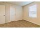 Bedroom with carpet, door, and window with blinds at 1621 Fuma Leaf Way, Mcdonough, GA 30253