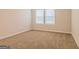 Bright bedroom with neutral carpeting and large window at 1621 Fuma Leaf Way, Mcdonough, GA 30253