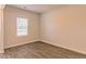 Simple bedroom with window and wood-look flooring at 1621 Fuma Leaf Way, Mcdonough, GA 30253