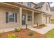 Two-story house with a beige brick facade and covered porch at 1621 Fuma Leaf Way, Mcdonough, GA 30253