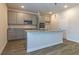 Modern kitchen with gray cabinets, granite counters, and island at 1621 Fuma Leaf Way, Mcdonough, GA 30253