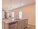 Kitchen island with granite countertop, sink, and stainless steel dishwasher at 1621 Fuma Leaf Way, Mcdonough, GA 30253