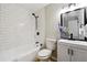 Updated bathroom with subway tile and a tub shower combo at 4742 West Dr, Forest Park, GA 30297