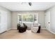 Bright living room with hardwood floors and large windows at 4742 West Dr, Forest Park, GA 30297