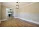 Separate dining area with hardwood floors and elegant light fixture at 785 Alice St, Forest Park, GA 30297