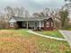 Brick ranch home with gray siding, covered porch, and landscaped yard at 2467 Shady Grove Rd, Carrollton, GA 30116