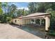 Covered carport with concrete flooring and access to the backyard at 1112 Warrenhall Ne Ln, Brookhaven, GA 30319