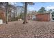 Spacious backyard with mature trees and wooden deck at 2707 Crescendo Nw Dr, Atlanta, GA 30318