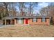 Brick ranch home with red door and landscaping at 2707 Crescendo Nw Dr, Atlanta, GA 30318