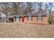 Brick ranch home with red door and landscaping at 2707 Crescendo Nw Dr, Atlanta, GA 30318