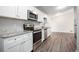 Modern kitchen with white cabinets, granite countertops, and stainless steel appliances at 2707 Crescendo Nw Dr, Atlanta, GA 30318