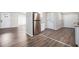 Open concept kitchen with stainless steel refrigerator and hardwood floors at 2707 Crescendo Nw Dr, Atlanta, GA 30318
