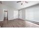 Living room with wood-look floors, ceiling fan, and entry hallway at 2707 Crescendo Nw Dr, Atlanta, GA 30318