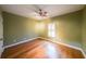 Bedroom with hardwood floors, ceiling fan, and plantation shutters at 2034 Haydenbrook Nw Dr, Acworth, GA 30101