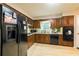 View of kitchen with black appliances and wood cabinets at 354 Tarragon Sw Way, Atlanta, GA 30331