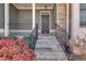 Front entryway with stone accents, covered porch, and landscaping at 243 Yorkshire Ln, Villa Rica, GA 30180