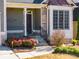 Front entry with stone accents, a covered porch, and landscaping at 243 Yorkshire Ln, Villa Rica, GA 30180