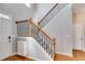 Open foyer with a staircase featuring wooden handrails and black wrought iron balusters at 243 Yorkshire Ln, Villa Rica, GA 30180