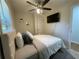 A comfortable bedroom featuring a ceiling fan, plush bedding, and wall-mounted TV at 3426 Treadwell Sw Cir, Atlanta, GA 30331