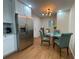 Kitchen breakfast nook with glass table and four teal chairs at 3426 Treadwell Sw Cir, Atlanta, GA 30331