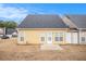 Back view of a yellow townhome with a small patio and storage unit at 9889 Vista Cir, Union City, GA 30291