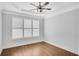 Bright bedroom with hardwood floors, plantation shutters and ceiling fan at 5435 Cole Creek Ln, Cumming, GA 30040