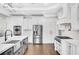 White kitchen with stainless steel appliances and a farmhouse sink at 5435 Cole Creek Ln, Cumming, GA 30040