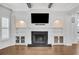 Elegant living room featuring a fireplace, built-in shelving, and hardwood floors at 5435 Cole Creek Ln, Cumming, GA 30040