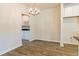 Modern dining room with wood-look floors and a stylish chandelier at 1620 Fuma Leaf Way, Mcdonough, GA 30253