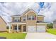 Two-story house with brick and vinyl siding, a three-car garage, and a well-manicured lawn at 1620 Fuma Leaf Way, Mcdonough, GA 30253