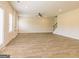 Open living room with fireplace and wood-look floors at 1620 Fuma Leaf Way, Mcdonough, GA 30253